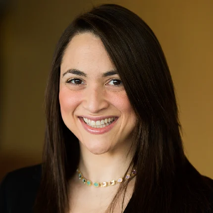 Cristina Jarbou Headshot. a woman with dark long hair wering a black blazer