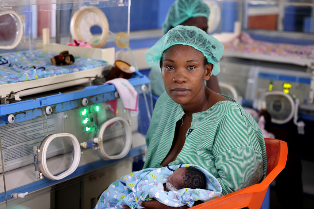 A mother holds her newborn baby in a hospital in Kenya.