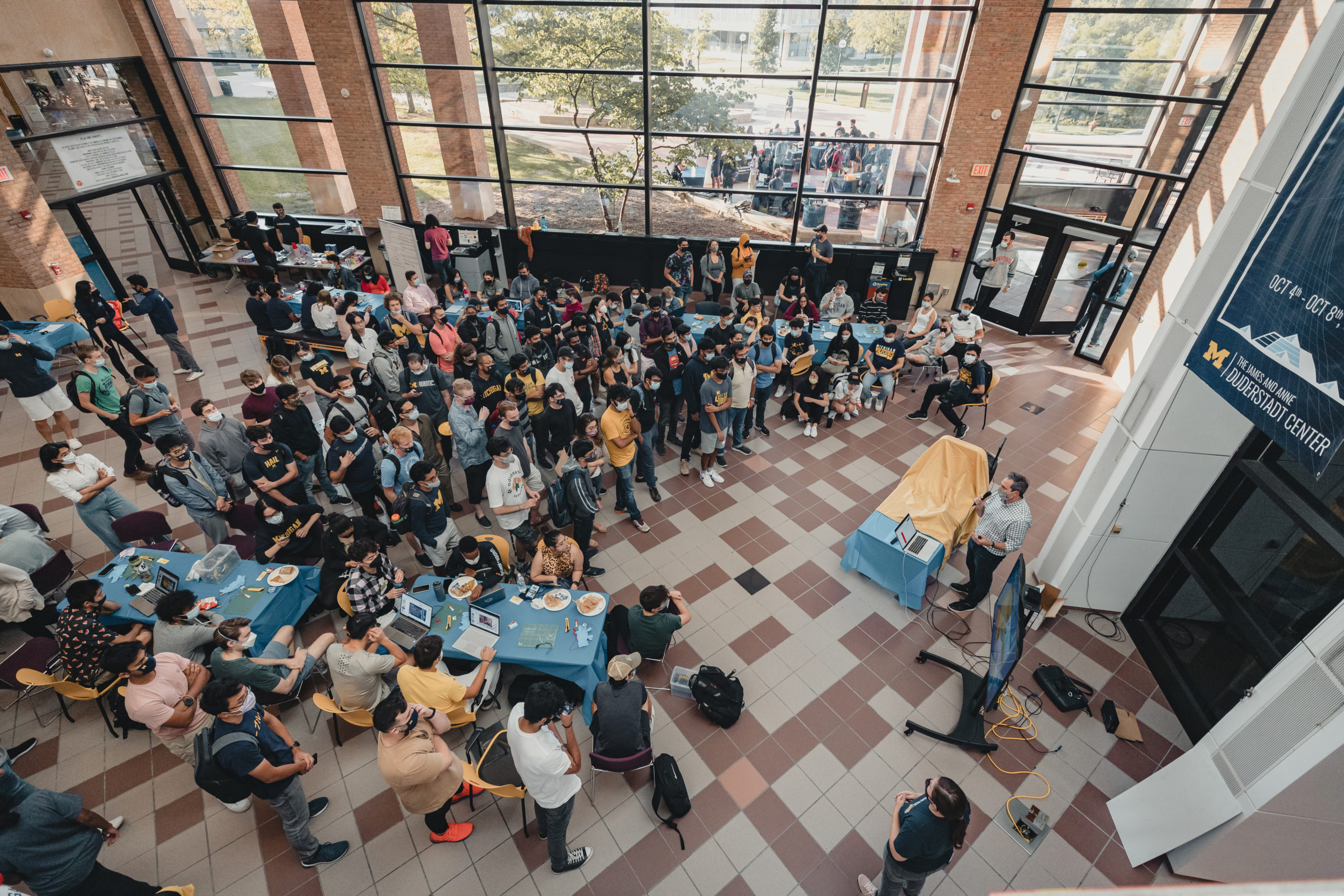 Aerial photo of large crowd gathered in the atrium of the Duderstadt Center