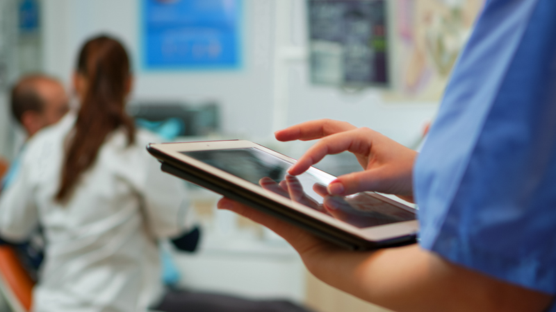 close up of nurse holding a tablet