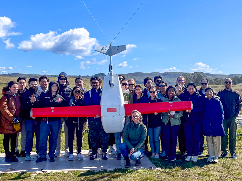 Group of students with Zipline plane