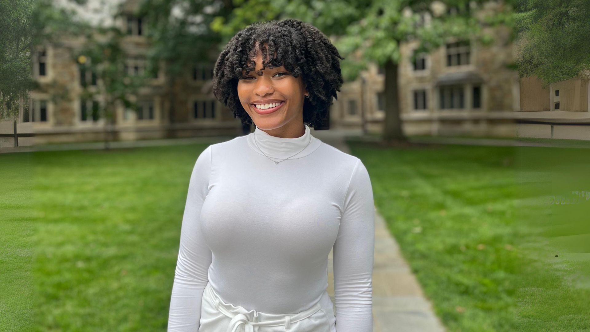 Nia poses in the law quad. She is smiling at the camera.