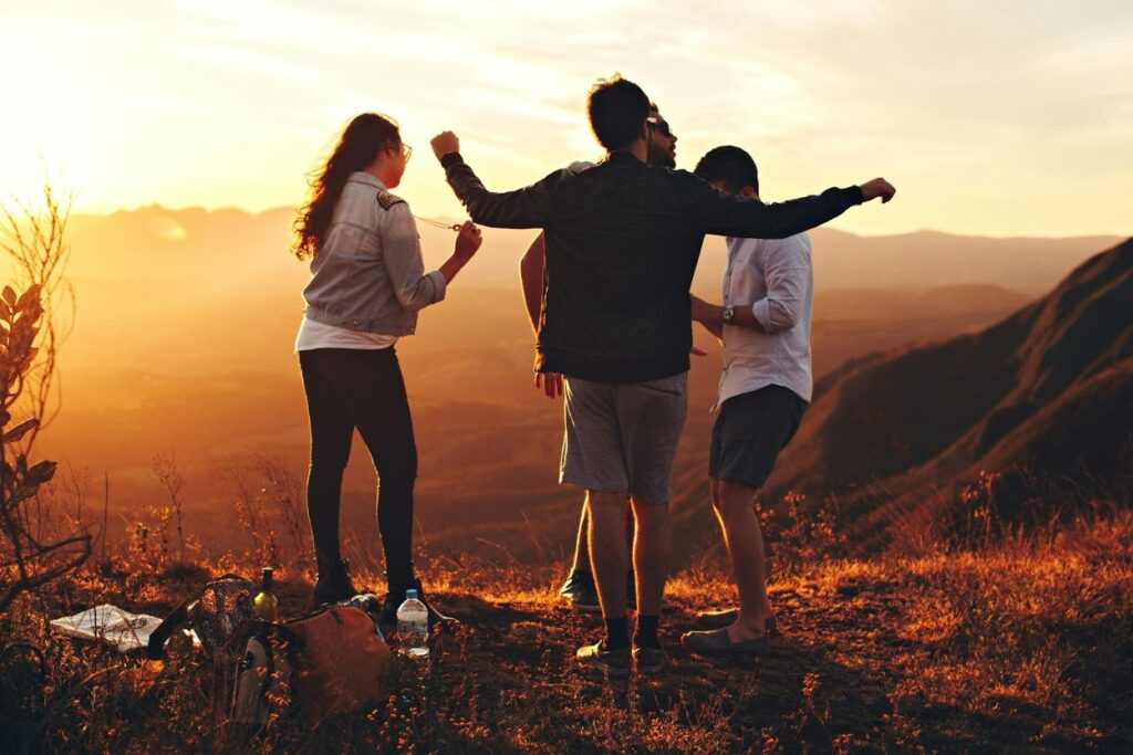 group of poeple on the side of a mountain relaxing