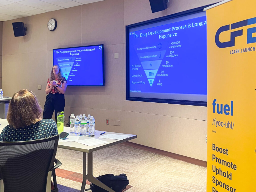 Woman pitching her idea in front of an audience