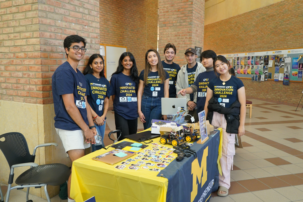 The Mpowered Innovation Challenge events team standing in a circle smiling at the camera