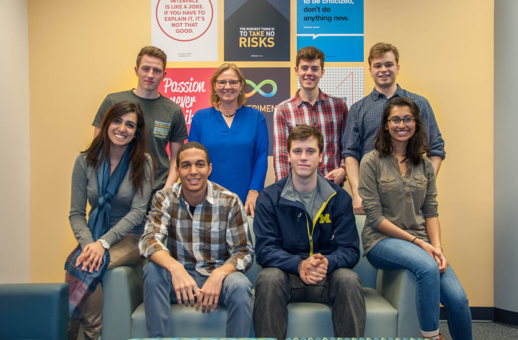 a diverse group of entrepreneurs sitting in two rows smiling for the camera