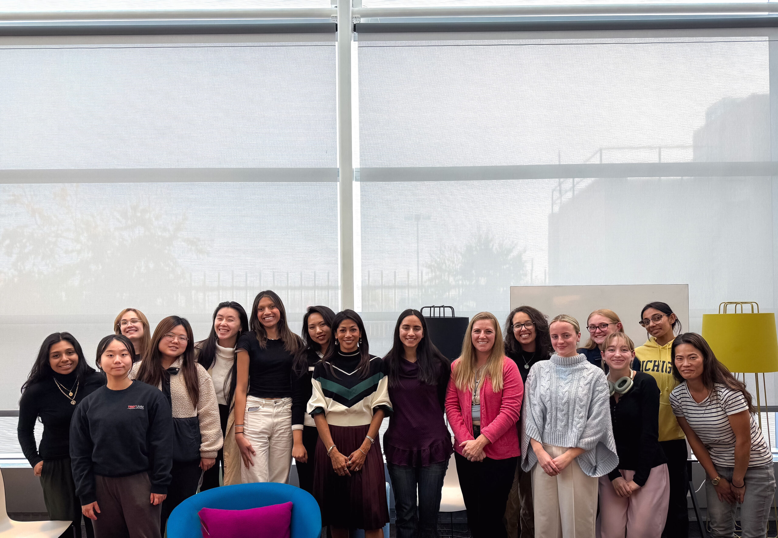 a diverse group of women entrepreneurs standing in a group smiling at the camera