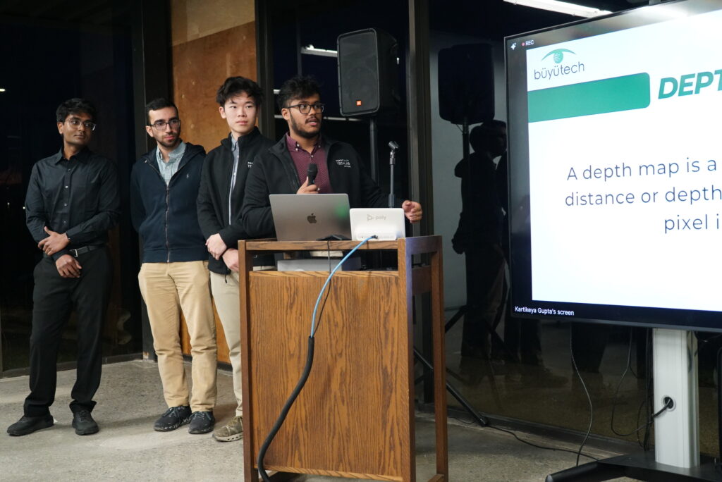 A group of four students present their final presentation.