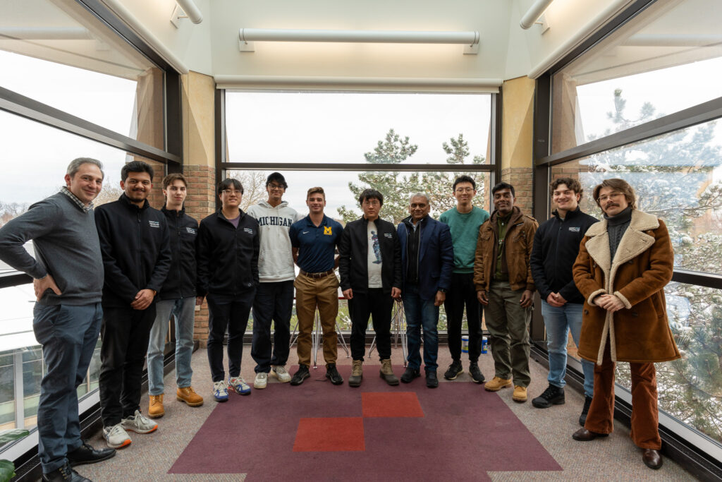 A group of students pose with Anurag Jain.