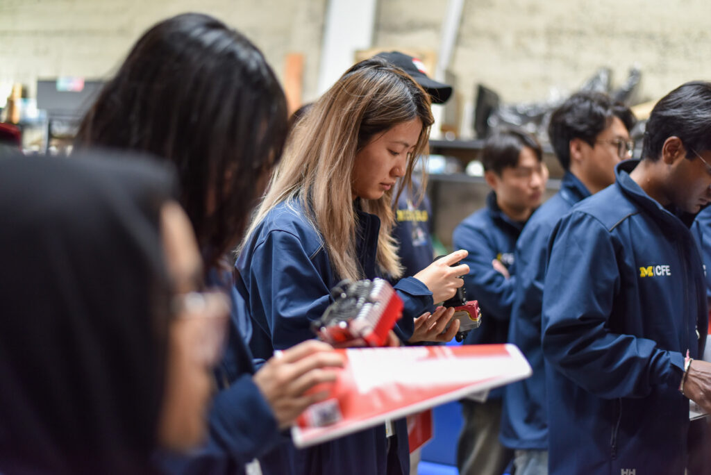 Students hold innovative tech from San Francisco startups at a trek stop