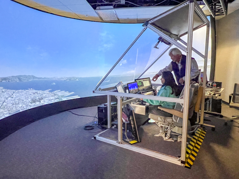 student and mentor in a flight simulator
