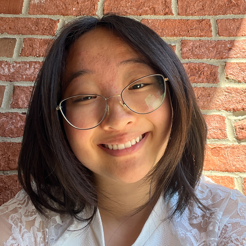 Tina Chao headshot, a woman with dark hair & glasses wearing a white shirt
