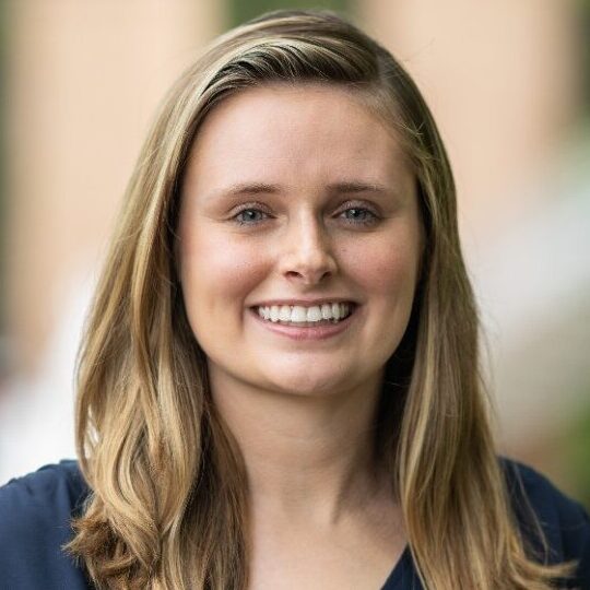 Kaitlin Keahl headshot a women with blond hair and a navy blouse