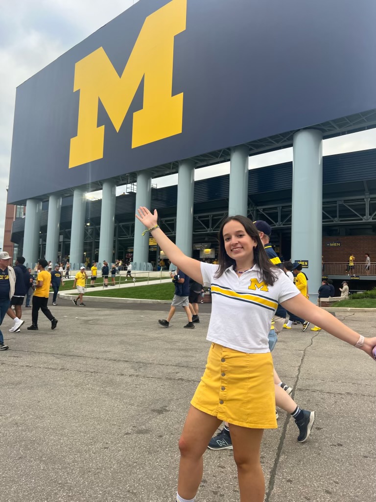 Julia poses in front of the big house, deked out in maize and blue.