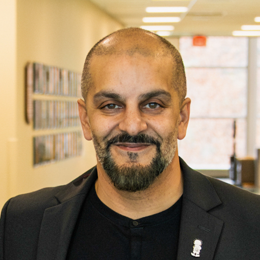 Biliad Saeed headshot a man wearing a black sport coat with a beard and mustache