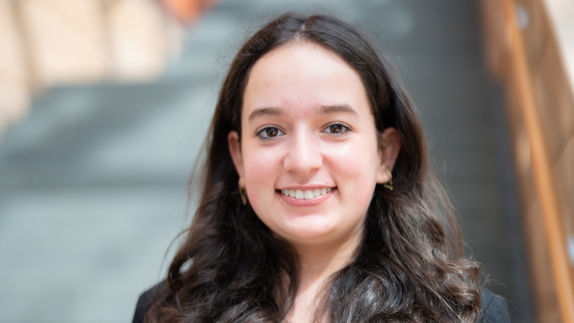 Julia smiles for a headshot.