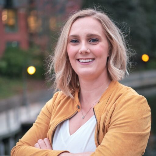 stephanie gowell a women with blond hair wearing a yellow sweater and white shirt