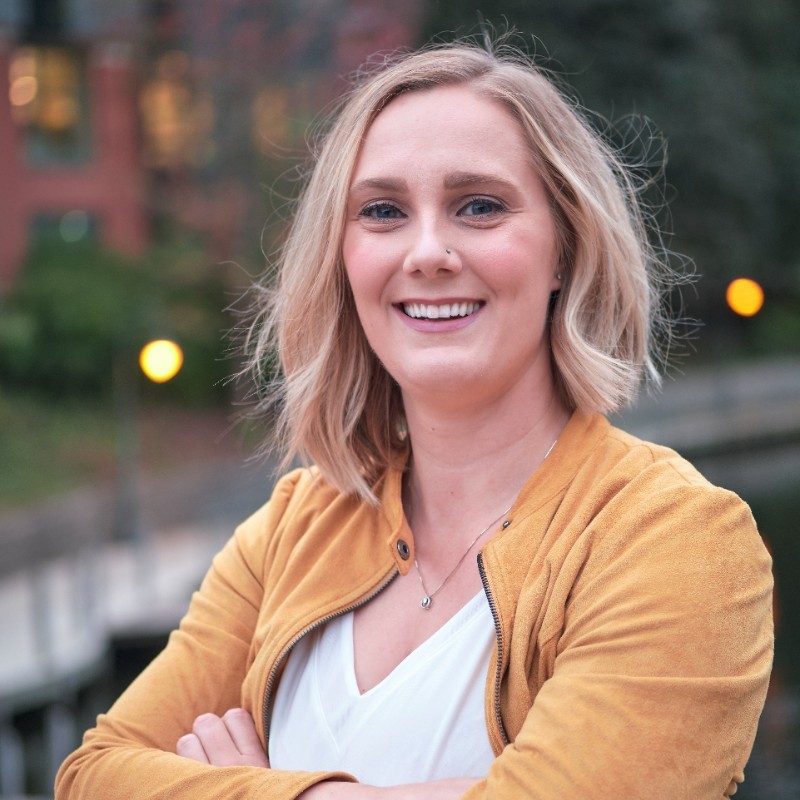 stephanie gowell a women with blond hair wearing a yellow sweater and white shirt