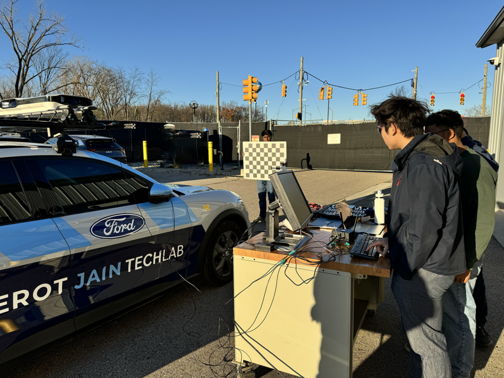 Students outside testing the Perot Jain TechLab Ford MachE