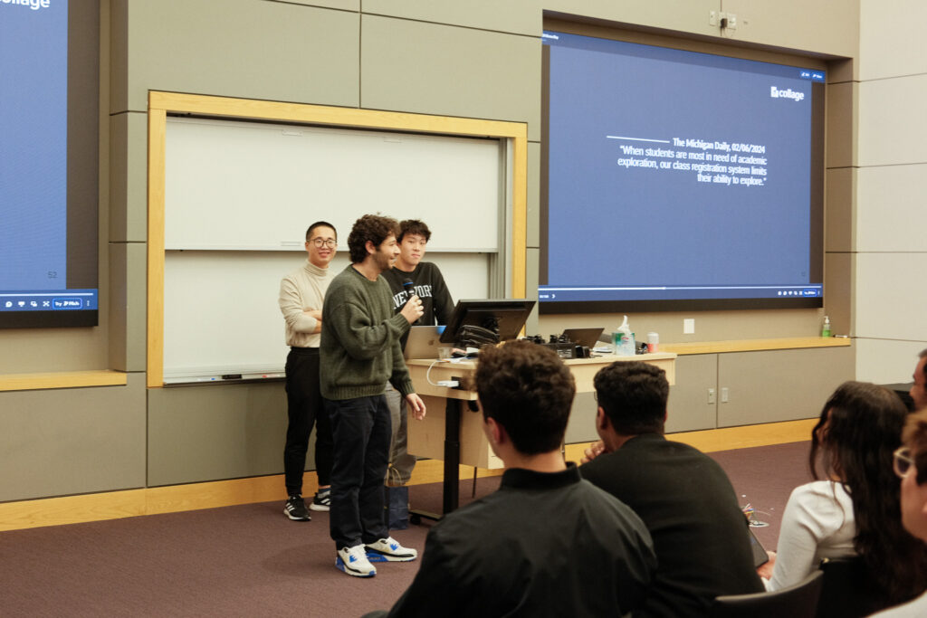 Max stands at the front of a classroom holding a microphone while pitching his startup, Collage.