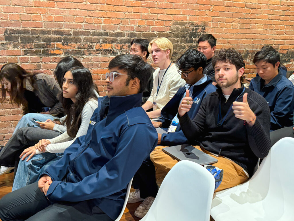 Max gives a thumbs-up while sitting with fellow students on a CFE Trek.