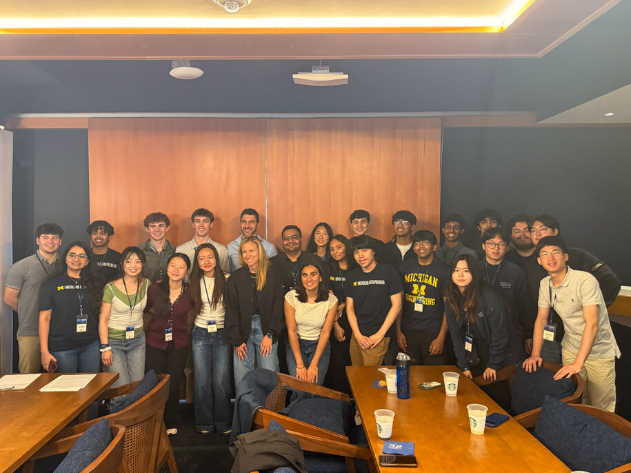 a group of students posing for the camera in a conference room