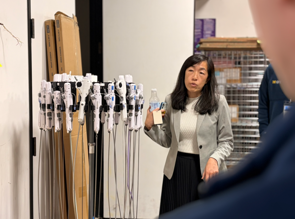 a woman standing next to medical devices giveing a demonstration