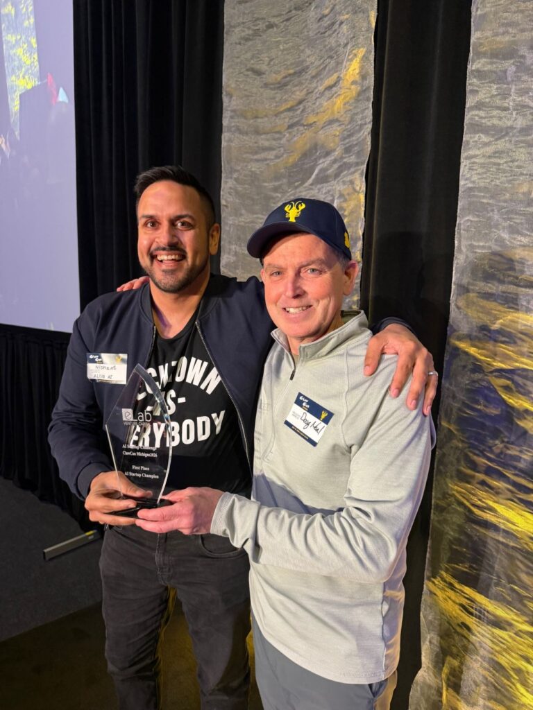Doug Neal presents the award for the Agent-First Startup Challenge to Alisio CEO Nishant Dixit.