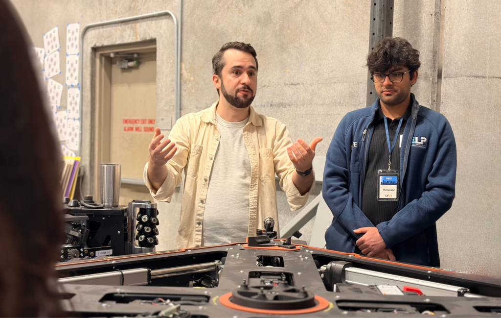 two men in front of a machine