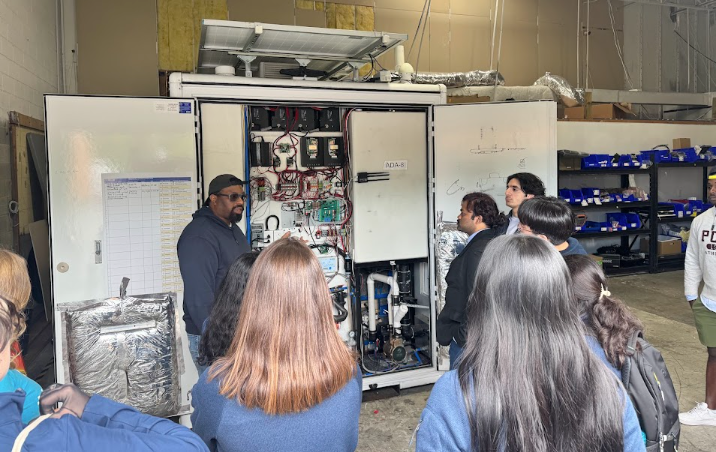 students examining the internals of a Throne Labs bathroom