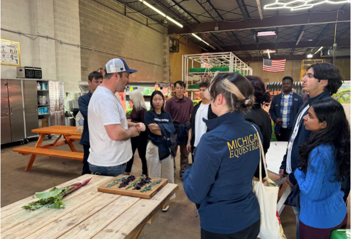 A group of students Trying produce grown at Area 2 Farms