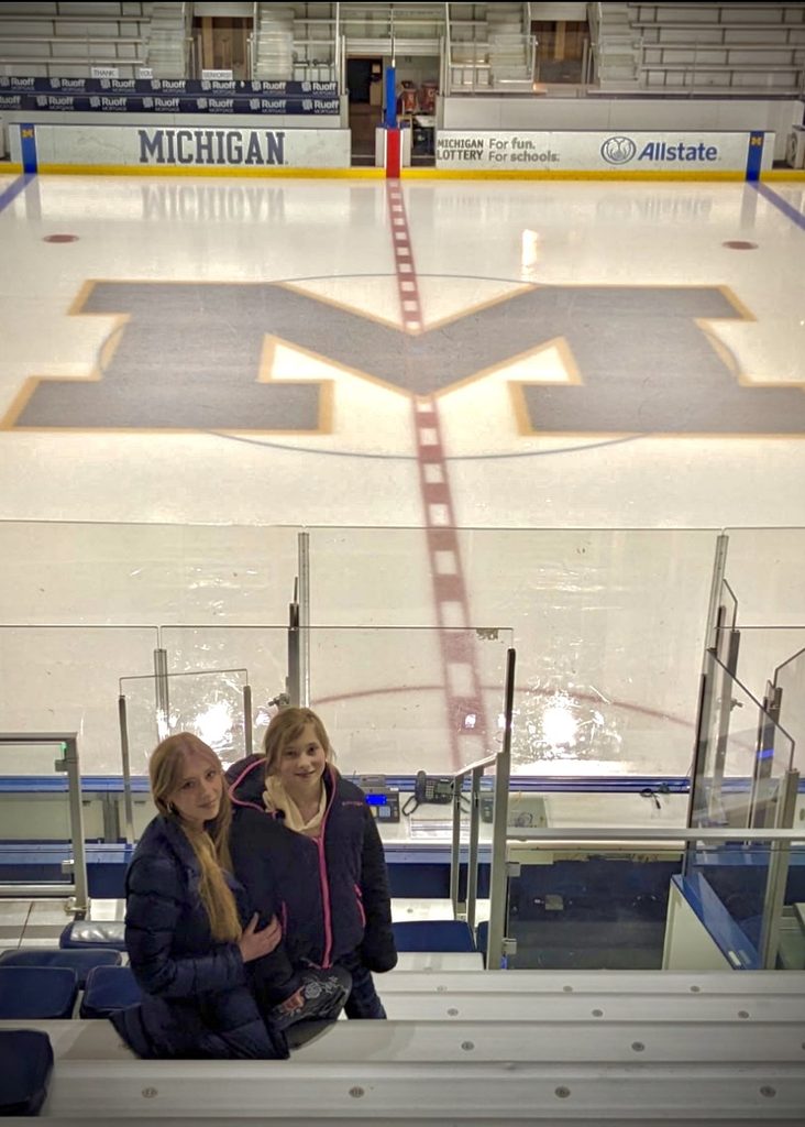 Delaney and her younger sister, Kenna, pose for a photo at Yost Ice Arena
