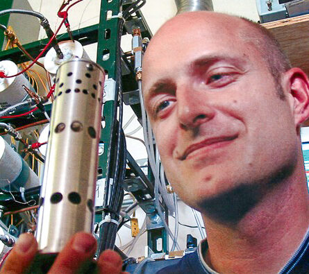 aaron crumm holding his fuel cell technology