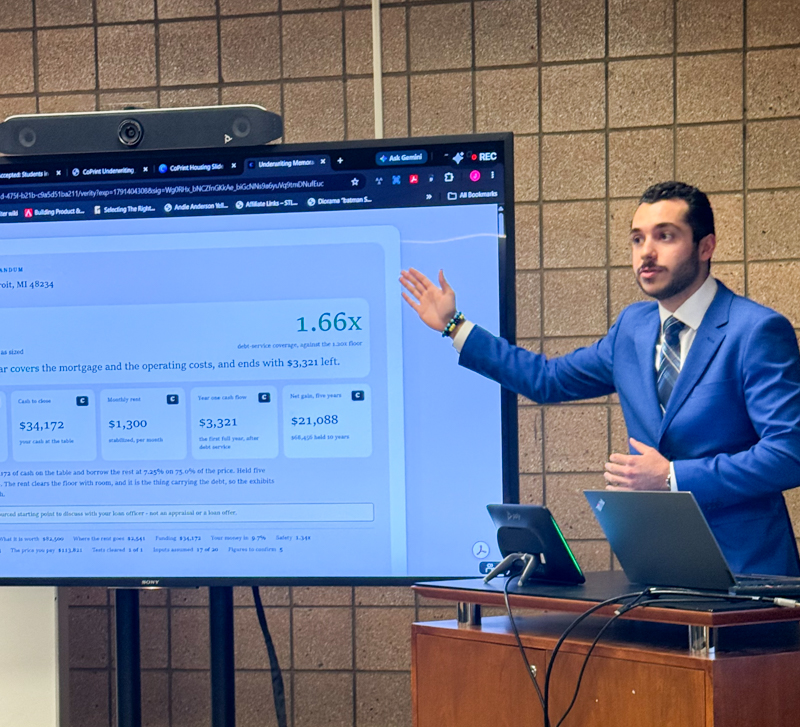 a man in a suit giving a presentation