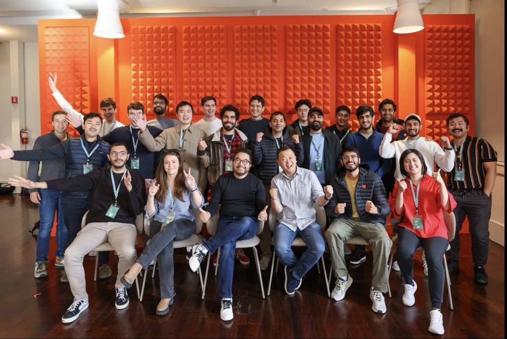 Arjan poses with colleagues in a large group photo